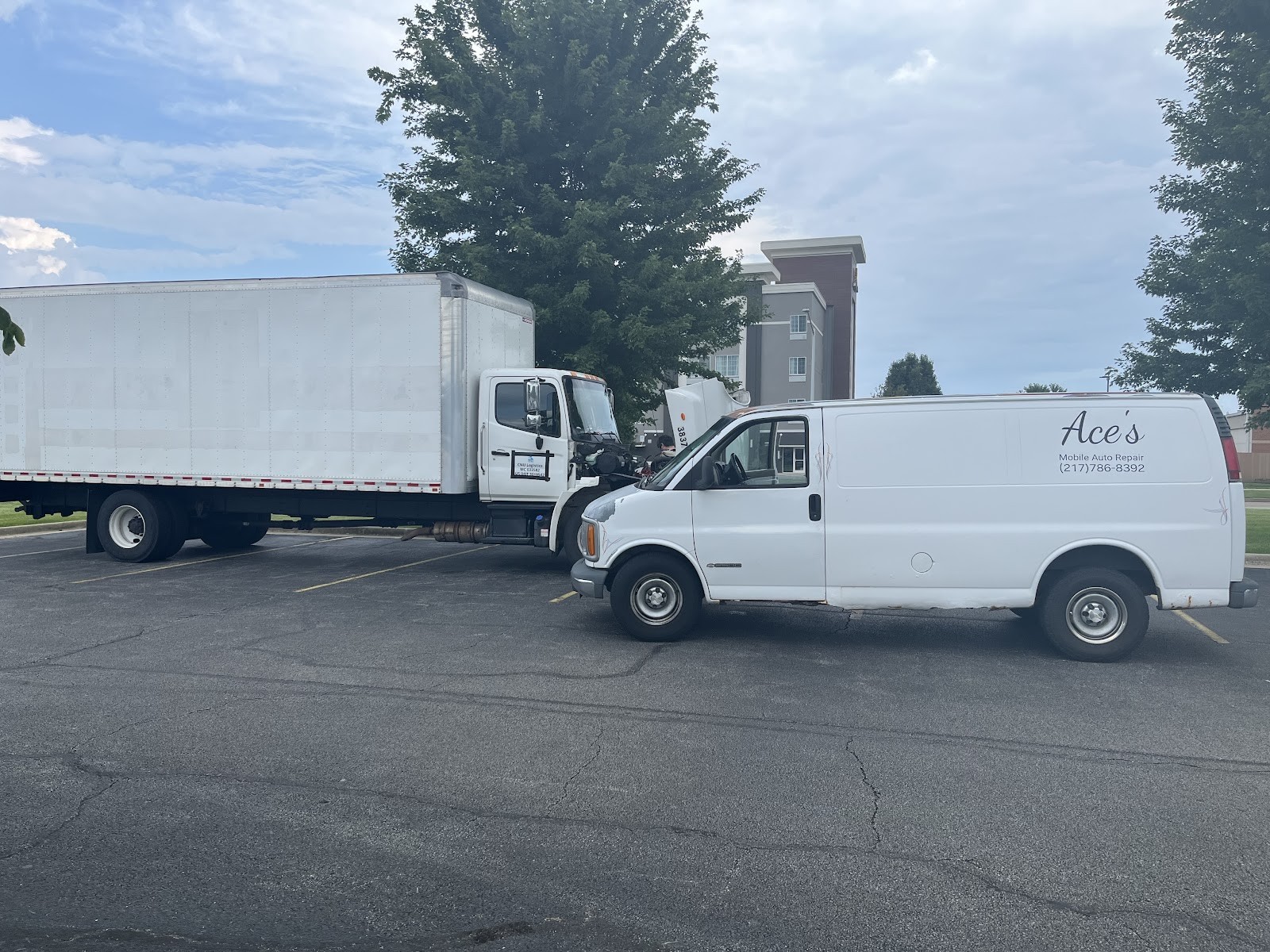 Ace's Mobile Auto Repair van parked next to a box truck in a parking lot